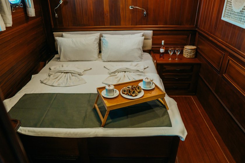 a rental boat's cabin small serve table with coffe on a bed