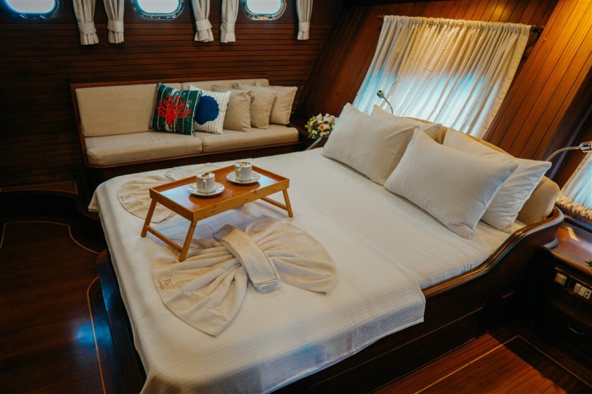 a small servis table on a bed in sailing turkey gulet