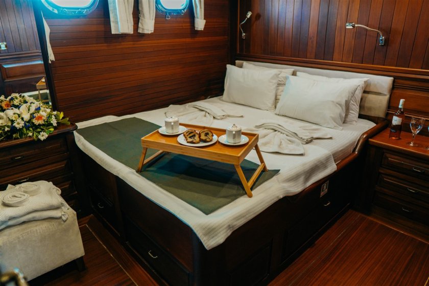 small service table on the bed in a sailing gulet's cabin