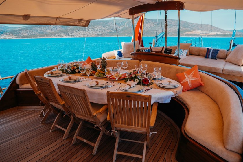 a dinner table on a back of sailing boat