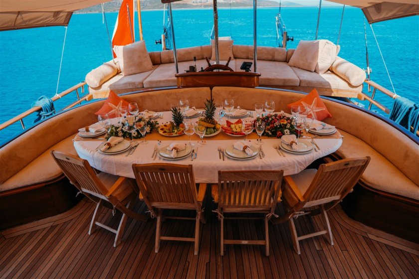 a dinner table with foods on a turkish sailing gulet
